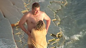 Munching her pussy on the beach